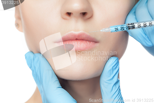 Image of Attractive woman at plastic surgery with syringe in her face