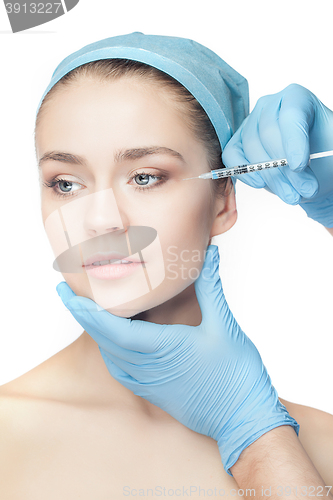 Image of Attractive woman at plastic surgery with syringe in her face