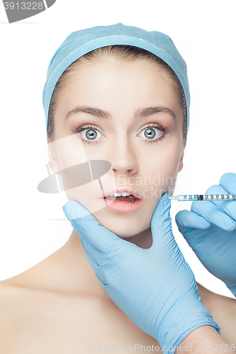 Image of Attractive woman at plastic surgery with syringe in her face