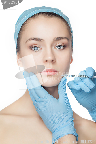 Image of Attractive woman at plastic surgery with syringe in her face