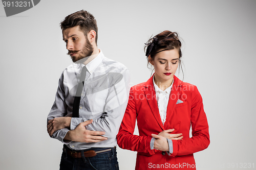 Image of The sad business man and woman conflicting on a gray background