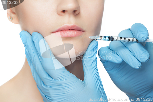 Image of Attractive woman at plastic surgery with syringe in her face