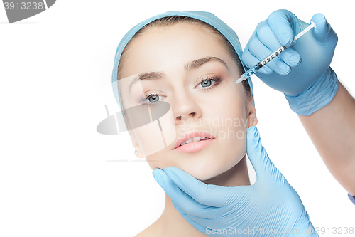 Image of Attractive woman at plastic surgery with syringe in her face