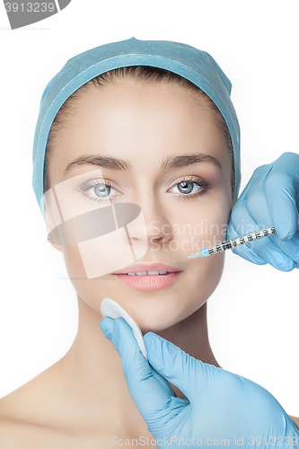 Image of Attractive woman at plastic surgery with syringe in her face