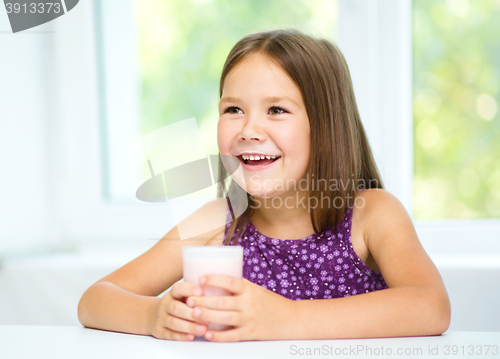 Image of Cute little girl with a glass of milk