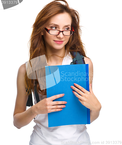 Image of Young student girl is holding book