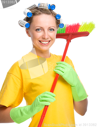 Image of Young woman with broom - cleaning concept