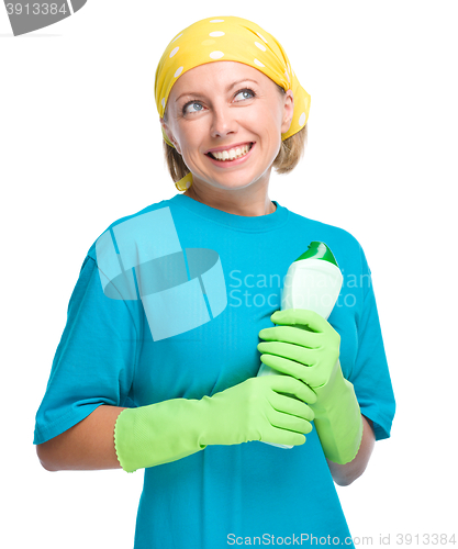 Image of Young woman with cleaning liquid