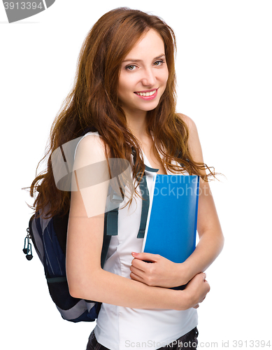 Image of Young student girl is holding book