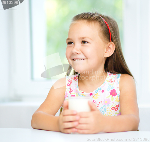 Image of Cute little girl with a glass of milk