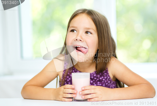 Image of Cute little girl with a glass of milk