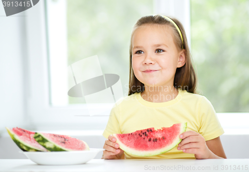 Image of Cute little girl is eating watermelon