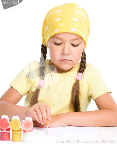 Image of Cute thoughtful child play with paints