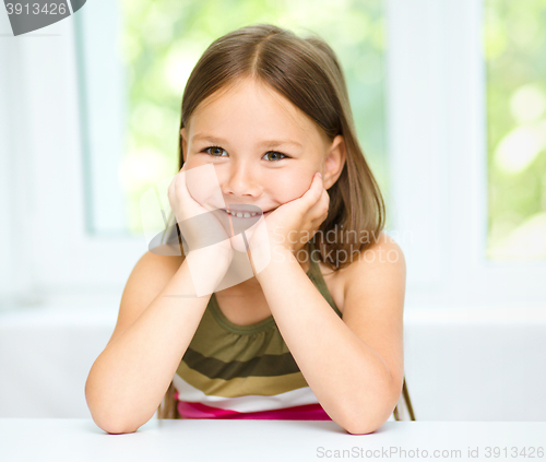 Image of Little girl is holding her face