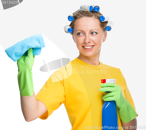 Image of Young woman is cleaning glass using rag