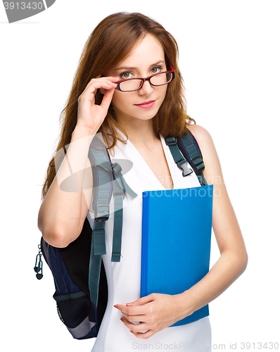 Image of Young student girl is holding book