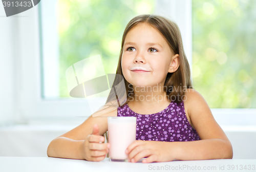 Image of Cute little girl with a glass of milk