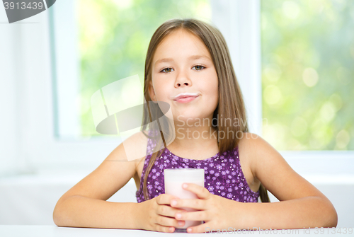 Image of Cute little girl showing milk moustache