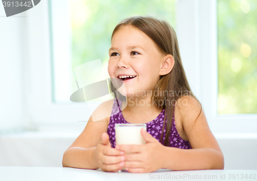 Image of Cute little girl with a glass of milk