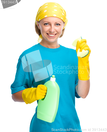 Image of Young woman with cleaning liquid and sponge