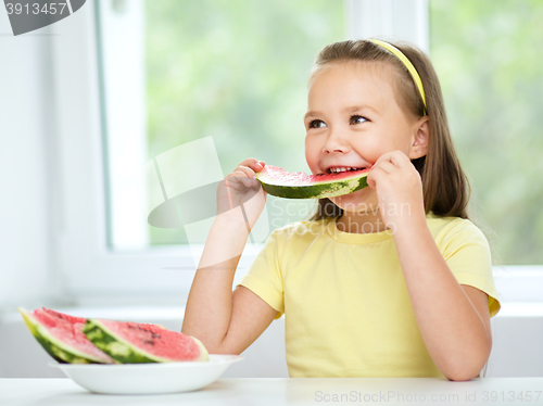 Image of Cute little girl is eating watermelon