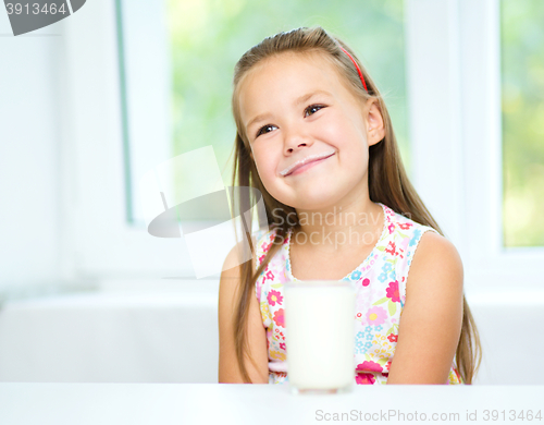 Image of Cute little girl with a glass of milk