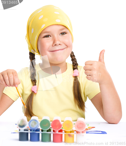 Image of Cute cheerful child play with paints