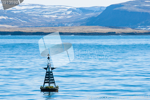 Image of Buoy silhouette in the blue ocean