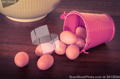 Image of Easter eggs in a violet bucket