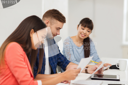 Image of happy creative team or students working at office