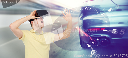 Image of man in virtual reality headset and car racing game