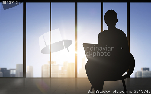 Image of silhouette of business woman with laptop