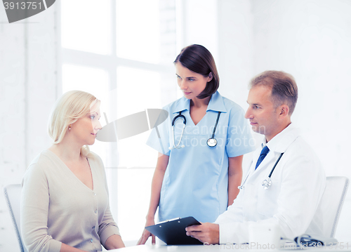 Image of doctor and nurse with patient in hospital