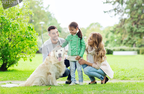 Image of happy family with labrador retriever dog in park