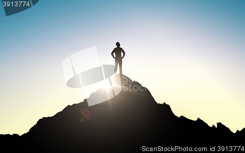 Image of silhouette of businessman on mountain top