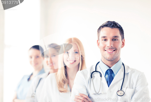 Image of male doctor in front of medical group