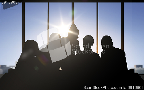 Image of business people silhouettes over office background