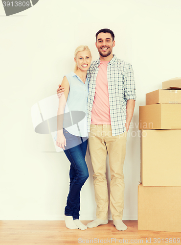 Image of couple with cardboard boxes moving to new home