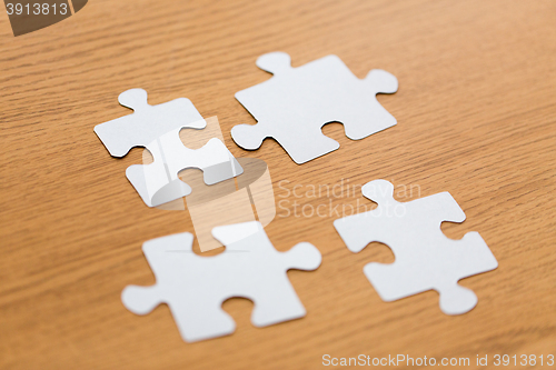 Image of close up of puzzle pieces on wooden surface