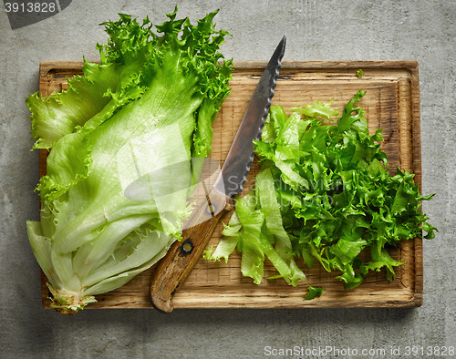 Image of fresh green lettuce on wooden cutting board