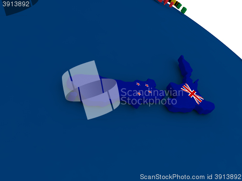Image of New Zealand on globe with flags