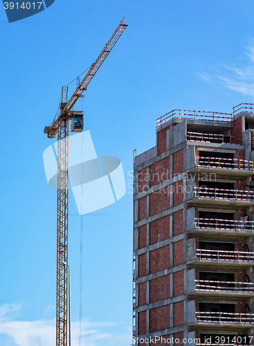 Image of Building Crane and Building Under Construction