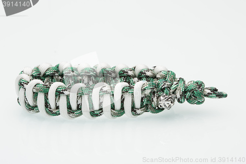 Image of green braided bracelet on white background