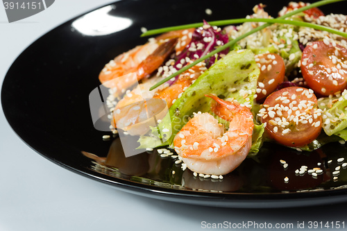 Image of perfect dish with shrimps on a black plate. seafood