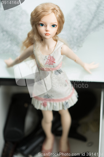 Image of doll in a box on a light background. blurred rear plan