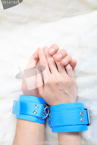 Image of Male and female hands in handcuffs. sexy couple in bed. sex Toys