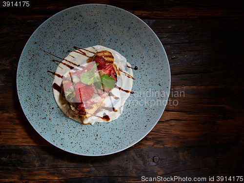 Image of Whole wheat Belgium waffle topped with syrup, whipped cream, walnuts and freshly chopped strawberries 