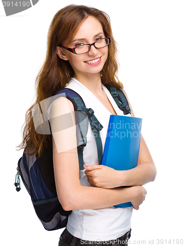 Image of Young student girl is holding book