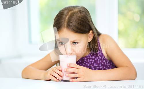 Image of Cute little girl with a glass of milk