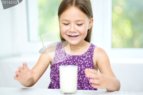 Image of Cute little girl with a glass of milk